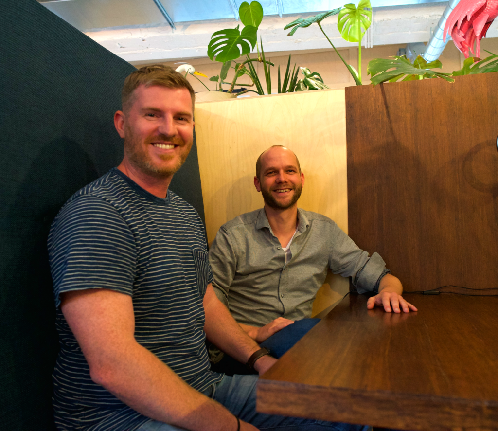 Robin on the left and Paul on the right in one of the seat booths at 42workspace's common space.